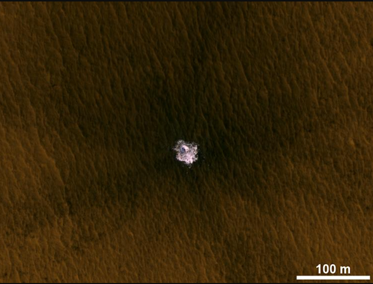 an image of the surface of Mars with a little bit of ice uncovered