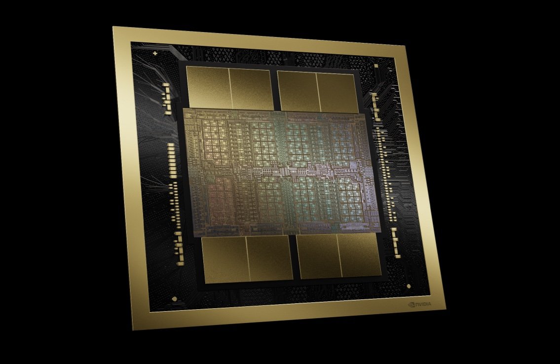 A gold-framed computer chip in opposition to a dark background.