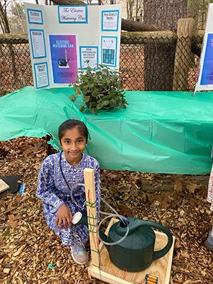 Anaina Cheedella with the motorized pump she developed with serve from her teacher to water vegetation