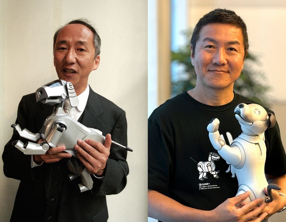 Two side by side photos of Japanese men holding small robotic dogs, the man on the left is older and is holding an older model robot, while the man on the right is middle aged and is holding a newer model robot.